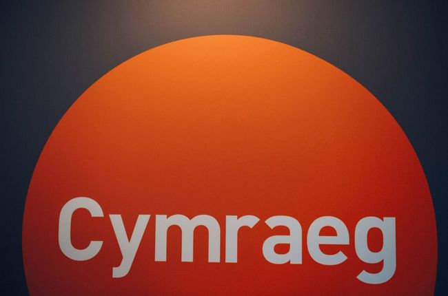 Arwydd logo iaith gwaith oren